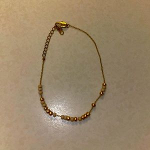 This is a Morse code bracelet in gold and pink!